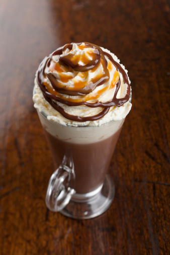 Hot Chocolate topped with fresh whipped cream, Caramel and Chocolate sauce.