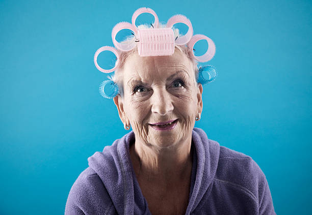 Senior woman with curlers Senior woman, 68 years old, with curlers in her hair. ugly old women stock pictures, royalty-free photos & images
