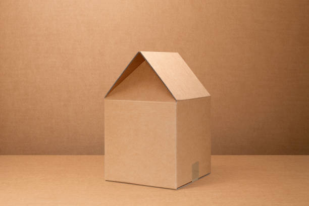 Moving home. Cardboard box shaped house. Moving house. Cardboard box shaped house.   cardboard house stock pictures, royalty-free photos & images