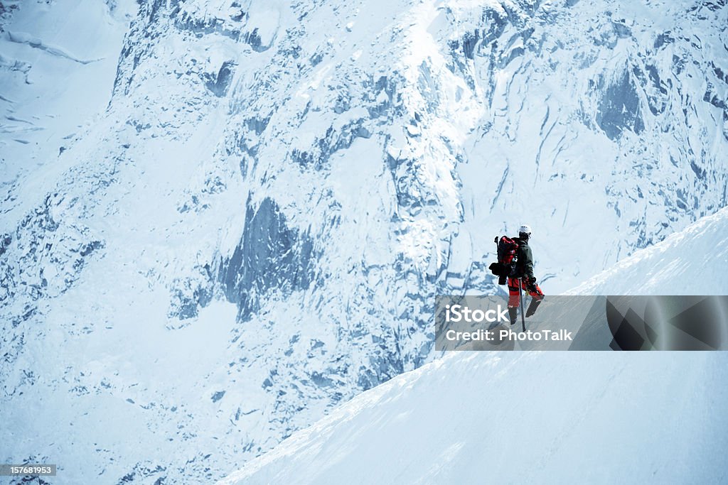 Male Adventurer Walking On Snow Mountain - XLarge An adventurer is climbing mountain of Alps in Europe Snow Stock Photo