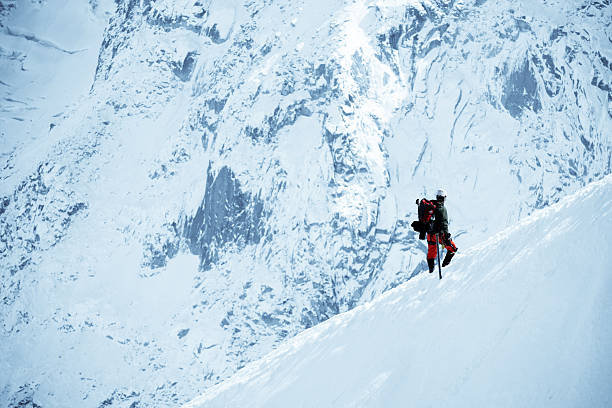 Male Adventurer Walking On Snow Mountain - XLarge An adventurer is climbing mountain of Alps in Europe climbing up a hill stock pictures, royalty-free photos & images