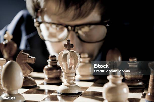 Chess Competition Player In Glasses Thinking About Next Move Stock Photo - Download Image Now