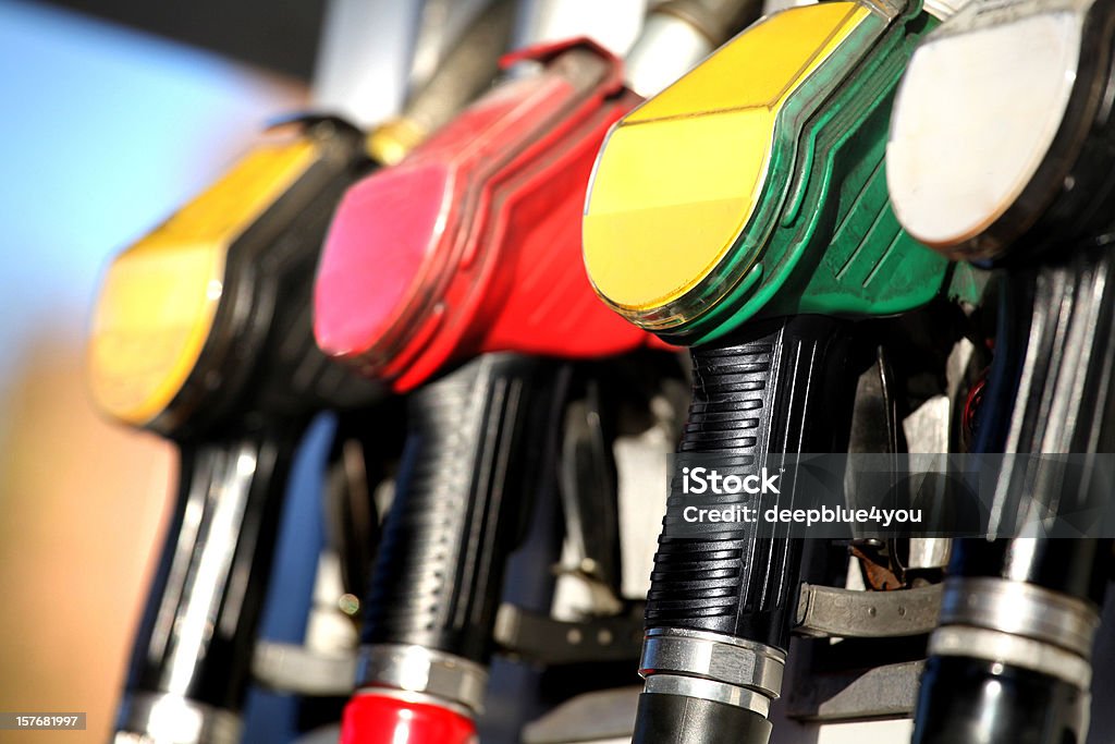 Fuel pump nozzles close up in a service station colorful petrol pumps Fossil Fuel Stock Photo