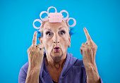 Senior woman making obscene gesture