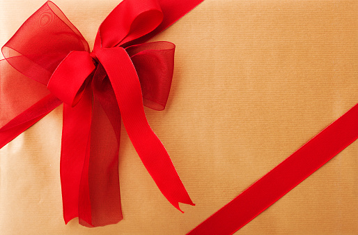 close-up of gold gift box with ribbon and bow