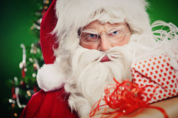angry santa claus with christmas gifts - santa hat bildbanksfoton och bilder