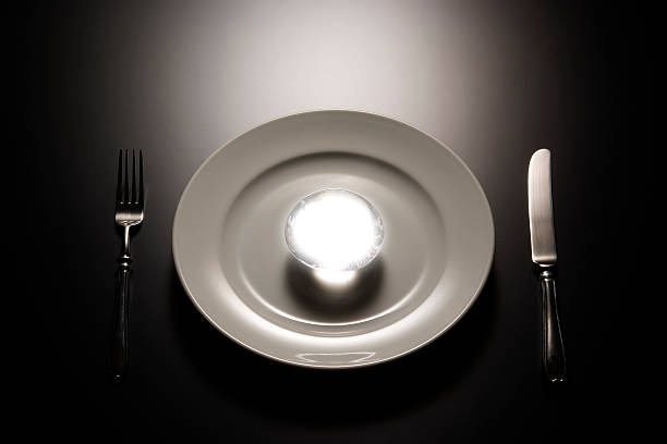 istock White plate with shining crystal ball on black table 157682371