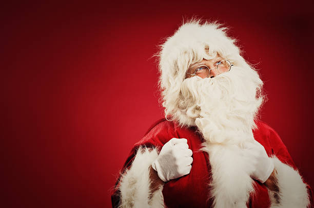 istock Happy Santa Claus isolated on red 157682451