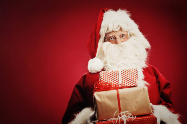 istock Happy Santa Claus isolated on red 157682527