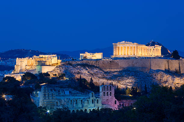 The Acropolis in Athens, Greece The Acropolis in Athens with the Theater of Herodes Atticus in the foreground and the Propylaea, the Erechtheum and the Parthenon on the mountain top. parthenon athens photos stock pictures, royalty-free photos & images