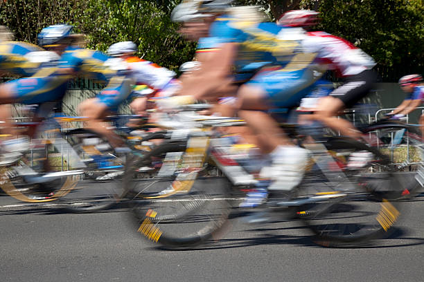 Motion blur as female cyclists race by at speeds of approx 60 km/hr