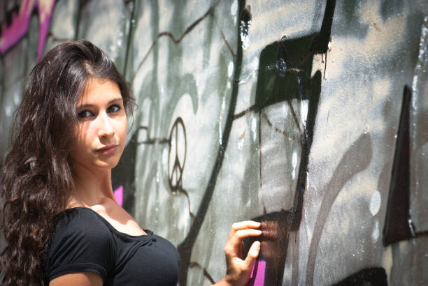 istock Beautiful woman model against graffiti wall background 157682767