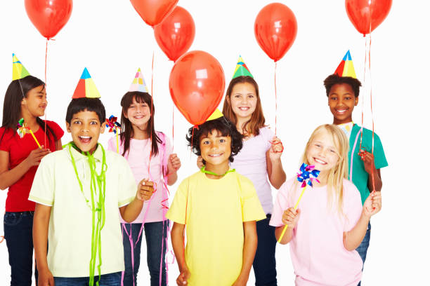 istock Multi ethnic kids holding red balloons enjoys birthday party 157683067
