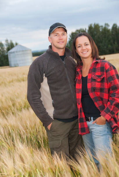 istock Young couple standing in a wheat field on farm 157683193