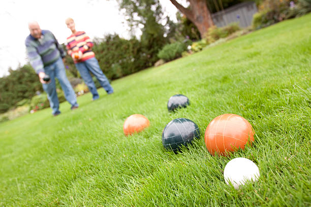 Couple playing bocce ball - horizontal stock photo