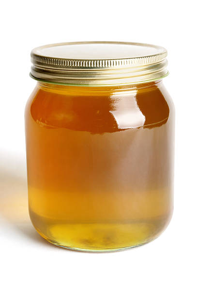 istock Golden honey in a single glass jar 157683568