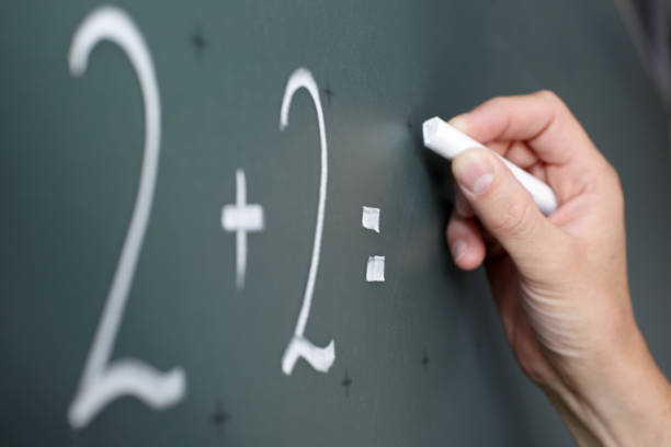 istock Male hand with chalk calculating on a black board 157683574