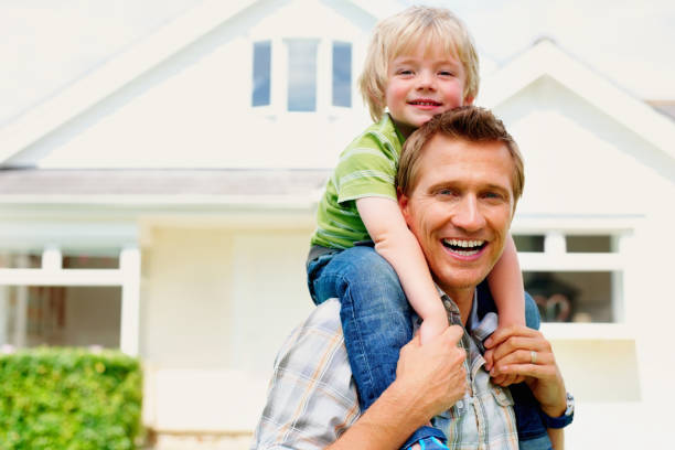 istock Mature man carrying his son on shoulders otdoor 157683612