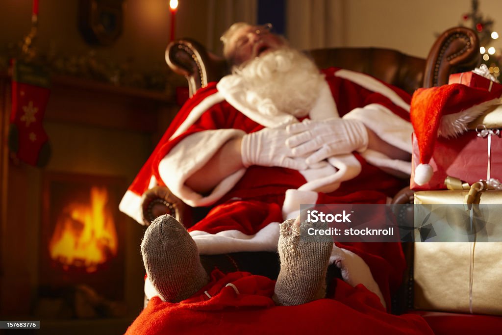 Father Christmas sleeping in grotto  Santa Claus Stock Photo