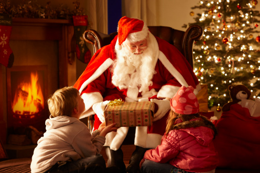 Santa Claus inside a home, blowing magical dust in the air