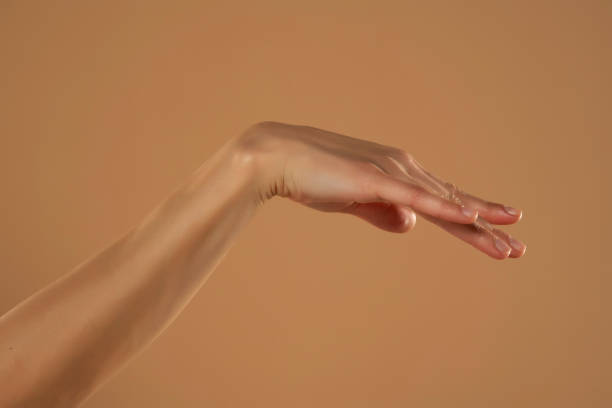 istock Female hand and palm isolated on beige background 1576838321