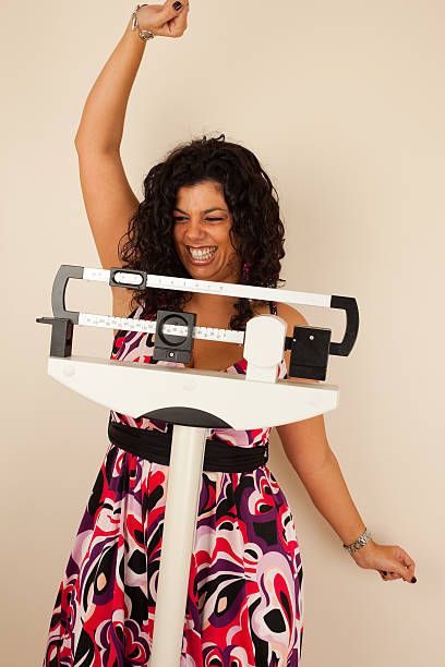 istock Woman celebrating her extreme weight loss 157683887