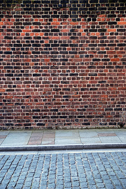 istock Urban background UK - Red brick wall with sidewalk 157683916