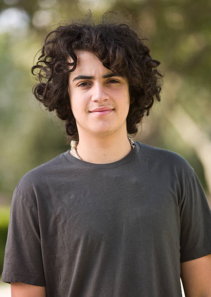 istock A young boy in a grey top poses for the camera. 157684080
