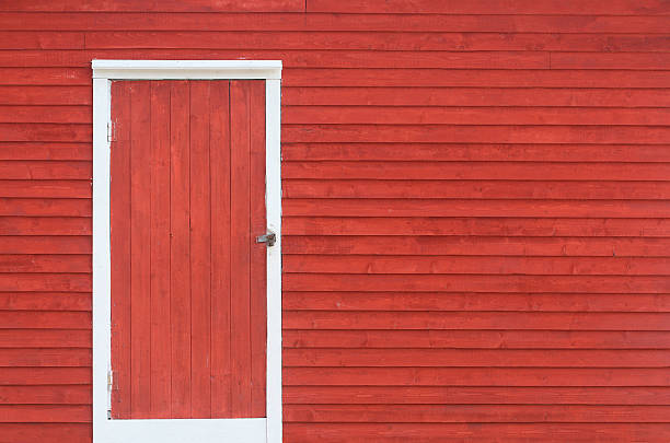 red door and exterior clapboard wall stock photo
