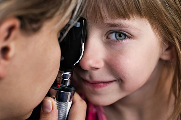 istock Little girl having eye exam 157684345