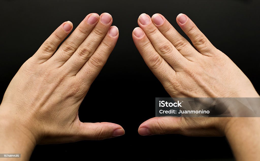 Woman's hands Real people, caucasian woman's hands on black background forming a triangle. In some countries this is a feminist hand sign   (this picture have been shot with a Hasselblad HD3 II 31 megapixels)  Triangle Shape Stock Photo