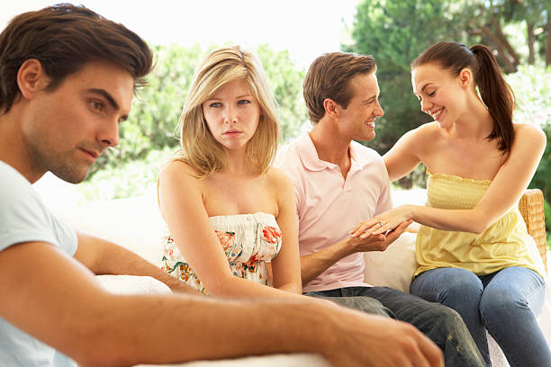istock Couple With Problems Amongst Group Of Friends Relaxing On Sofa 157684795