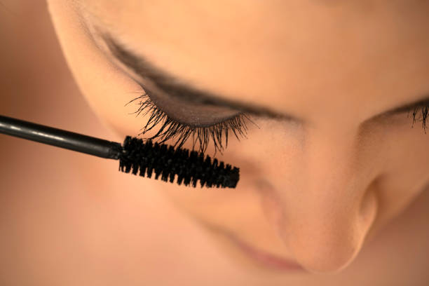 istock woman applying mascara 1576848259