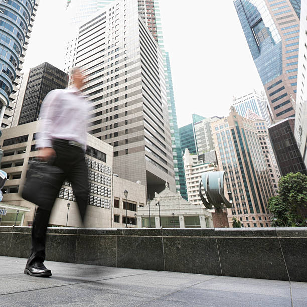 istock Singapore businessman walking through the Central Business District. 157684832