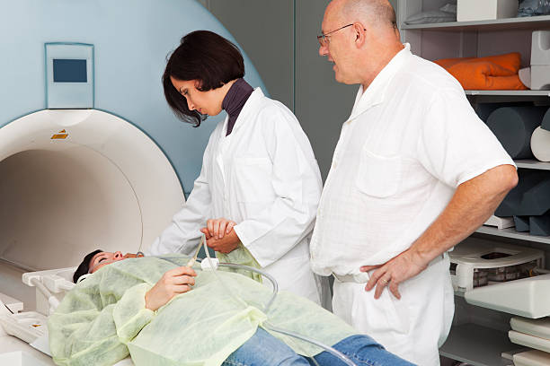 istock Chief Radiologist,beautiful young doctor and patient before MRI scan 157684846