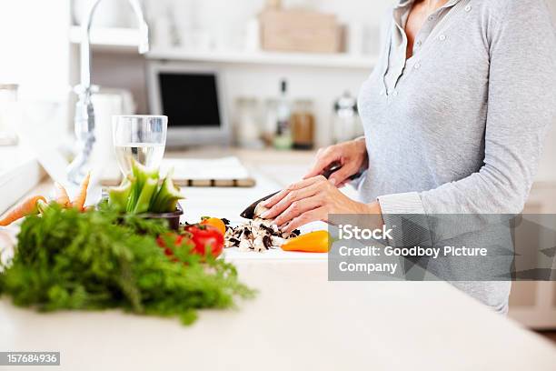 Mature Woman Cutting Vegetables In The Kitchen Stock Photo - Download Image Now - Cooking, Healthy Eating, Healthy Lifestyle