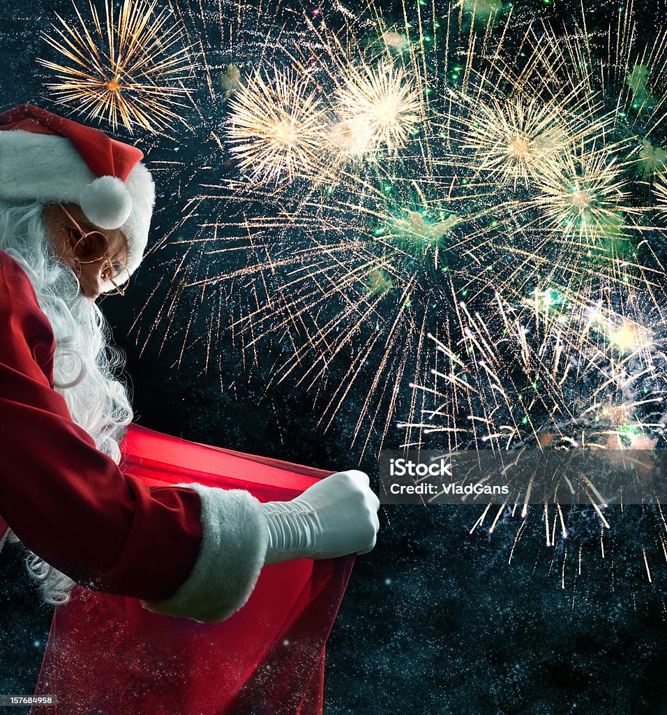 Santa holding a gif bag Santa holding a gif bag. On night sky background Firework Display Stock Photo