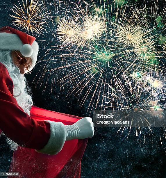 Santa Holding A Gif Bag Stock Photo - Download Image Now - Firework Display, Christmas, Gift