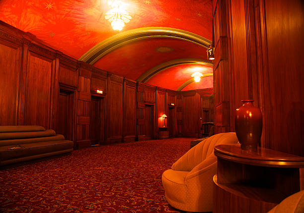 Luxury Lobby Lobby of the Casino a local landmark built in 1930's on Catalina Island with rich wood panelling and comfortable seating; the 'Casino isn't a gambling establishment but a public building with a movie theatre on the ground floor and ballroom on the top floor, the most recognizable landmark in the City of Avalon. It contains a theater, a ballroom, and a museum.Built by William Wrigley Jr. using Art Deco and Mediterranean Revival,12 stories tall.The upper level houses the world's largest circular ballroom with a 180-foot (55 m) diameter dance floor.The Avalon Theater, on the first level, shows first-run movies nightly. The theatre has one movie screen and a seating capacity of 1154. ballroom stock pictures, royalty-free photos & images