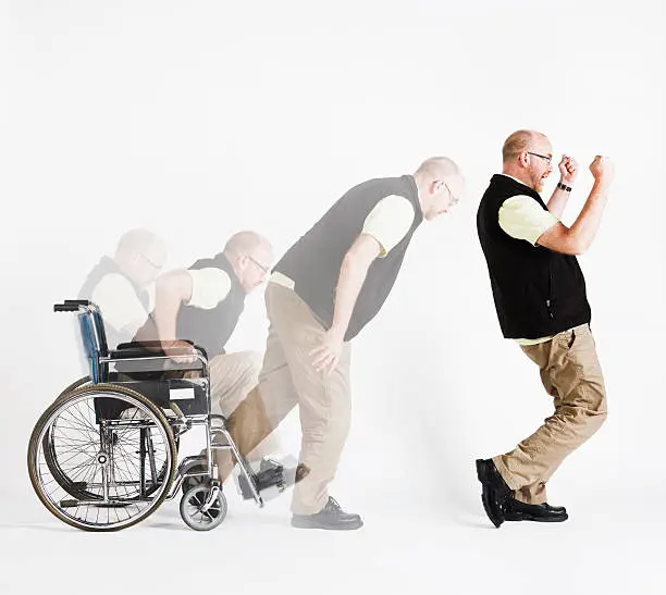 Photo of Disabled man rises from wheelchair, delighted, in composite multiple shot