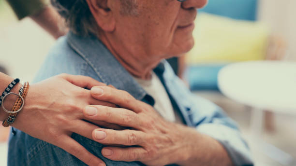 istock Comforting hand on shoulder of man 1576851385