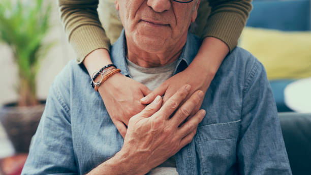 comforting hand on shoulder of man - dementia imagens e fotografias de stock