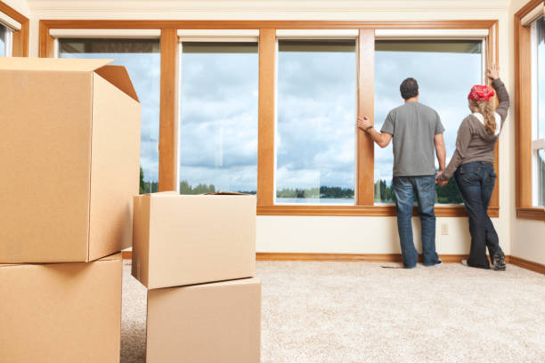 istock Young Couple in New Home with Moving Boxes 157685342