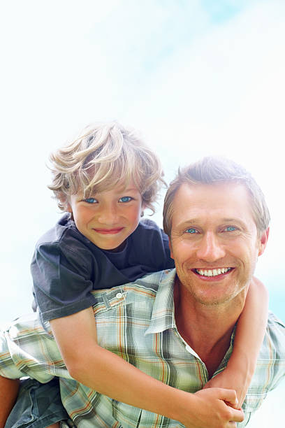 istock Smiling father giving his son piggyback ride 157685735