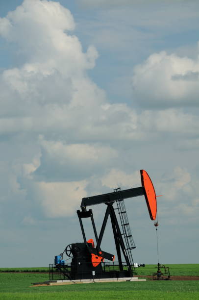 bomba de poço de petróleo no campo da fazenda isolado - oil pump oil alberta canola - fotografias e filmes do acervo