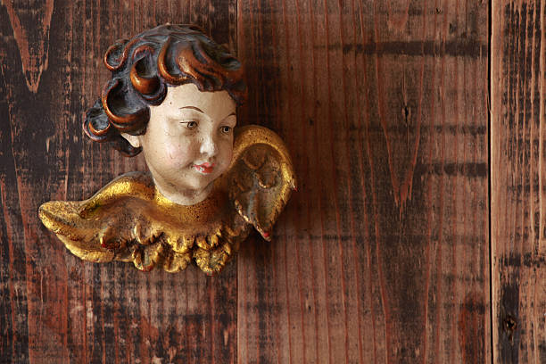approx. 200 years old wooden and painted baroque angel statue on wooden background. unknow origin, family heirloom.