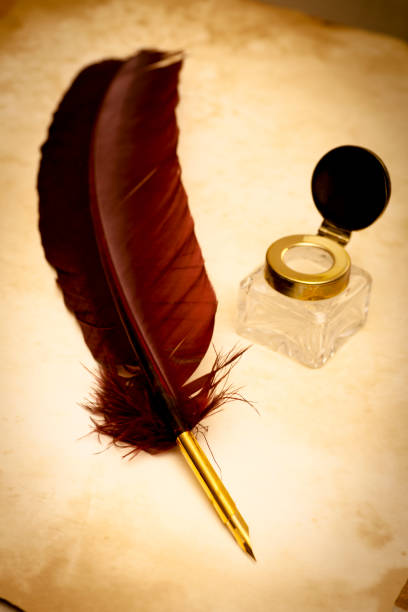 istock Quill pen and ink well on old parchment 157686163