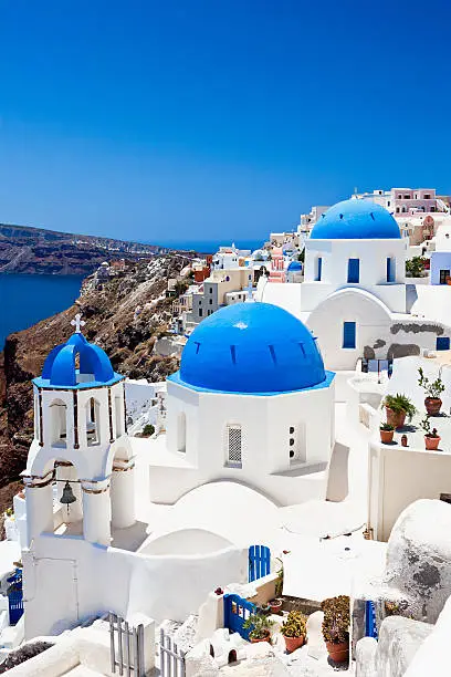 Famous Orthodox church with blue domes in village Oia (Ia) on Santorini island. Click for more images: