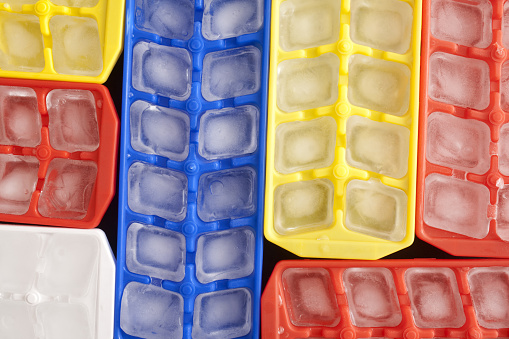 Top view of ice cubes in plastic containers