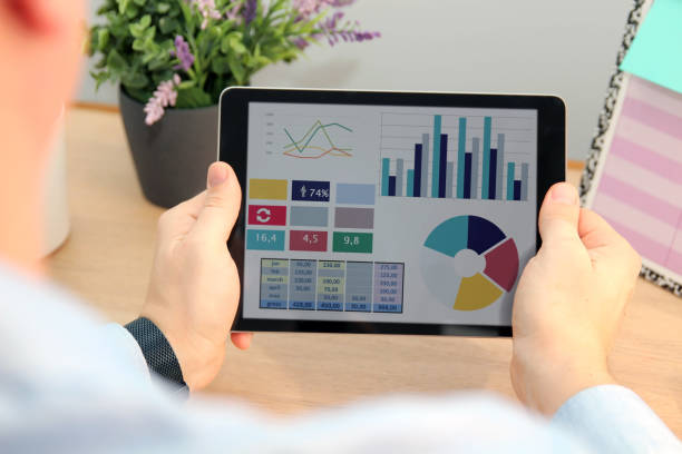 istock Business man working and analyzing financial figures on   a tablet 1576864243